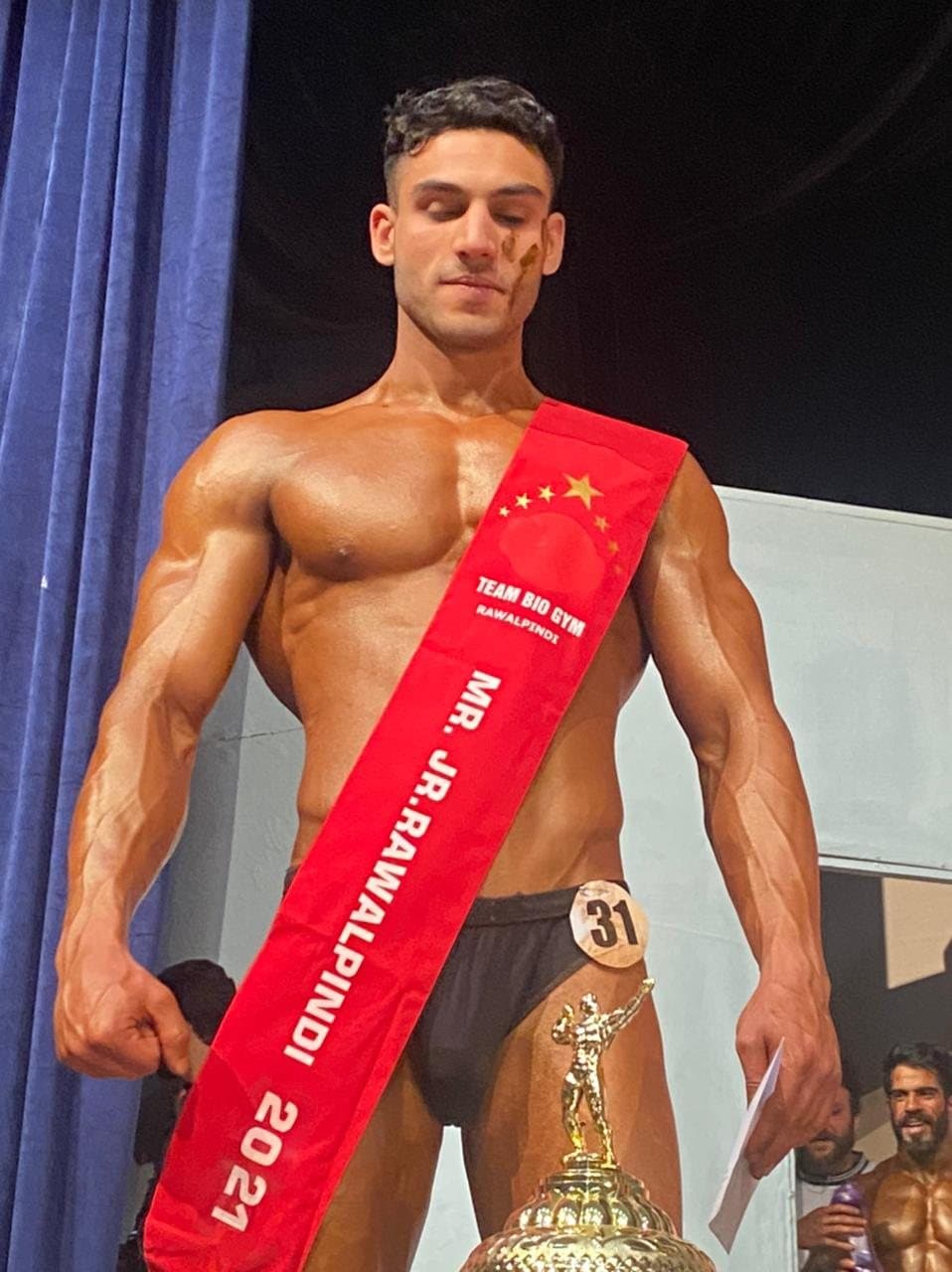 Asfand Khan on stage wearing the Mr. Jr. Rawalpindi 2021 sash, competitor number 31